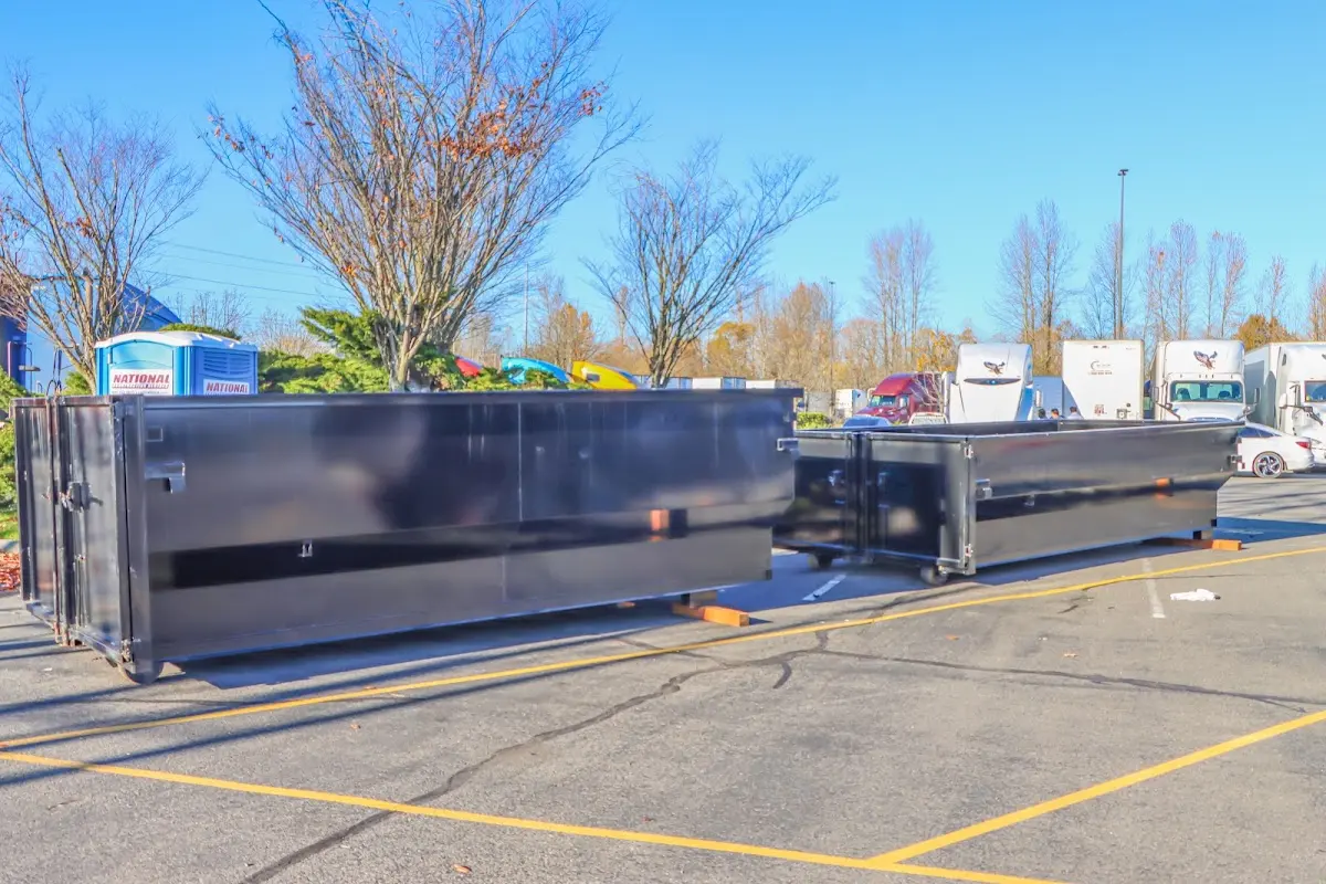Professional dumpster rental service with roll-off container on residential driveway in Homeland Park